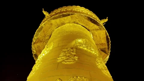 Golden Prayer Wheel Rotating in Close Up with Relief Carvings Stock Footage 340130985