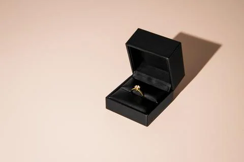 Golden proposal ring in box with single diamond Stock Photos