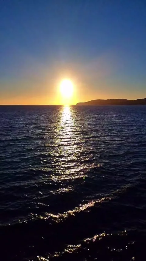 Golden Rays Over the Sea A Tranquil Sunset by the Water Stock Footage 286243881