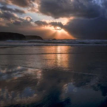 Golden Rays of the Setting Sun over the Shore of a Beach Stock Photos