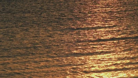 Golden Red Ocean Surface at Sunset with Moving Waves Видео 334019469