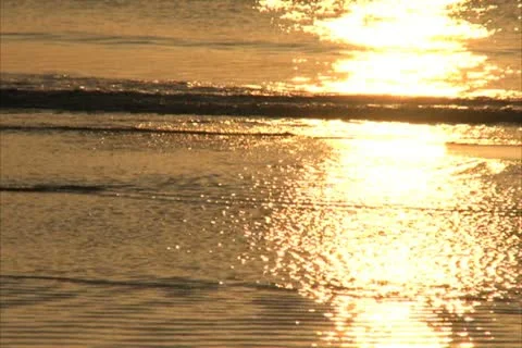 Golden Reflections on Beach Waves - NTSC Stock Footage 12310743