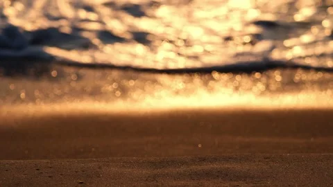 Golden reflections of the setting sun on the waves in out of focus Stock Footage 265233633