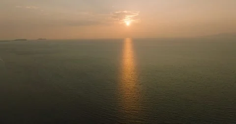 Golden reflections of sunset over calm ocean. Ko Pha Ngan, Thailand. Stock Footage 311618524