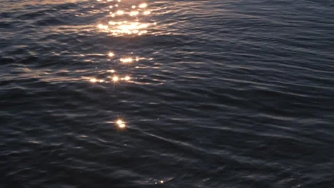 Golden reflections on the surface of dark sea waves Stock Footage 300441728