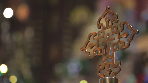 Golden religious cross on background of the lights in church. Stock Footage 80354510