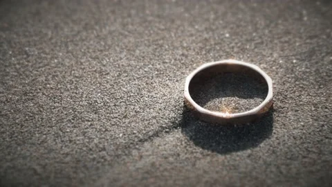 Golden ring on the beach in the sand Stock Footage 219223790