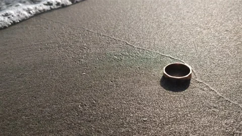 Golden ring on the beach in the sand Stock Footage 219223819
