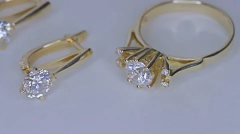 Golden ring with a diamond on white Stock Footage 56474488