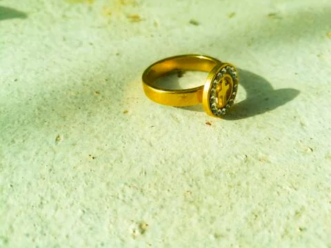 A golden ring placed on a white background. Stock Photos