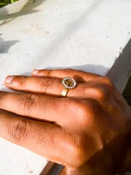 A golden ring placed on a white background. Stock Photos