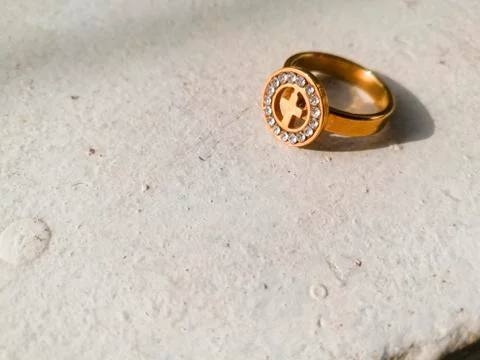 A golden ring placed on a white background. Foto stock