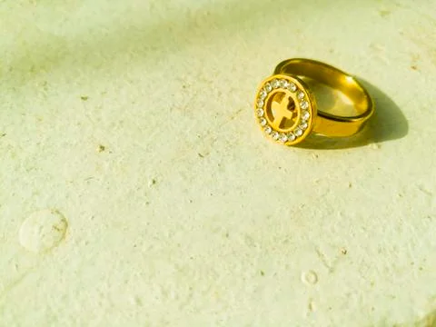 A golden ring placed on a white background. Stock Photos