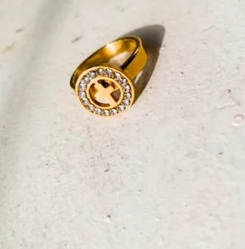A golden ring placed on a white background. Stock Photos