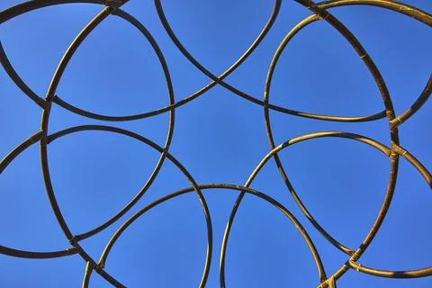Golden Ring Structure Against Blue Sky Spiritual Temple Abstract at Sunset Stock Photos