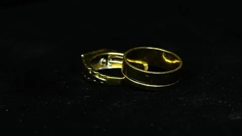 Golden Rings Rotating 360 Degrees on Black Background With Dim Light 스톡 동영상 334446804