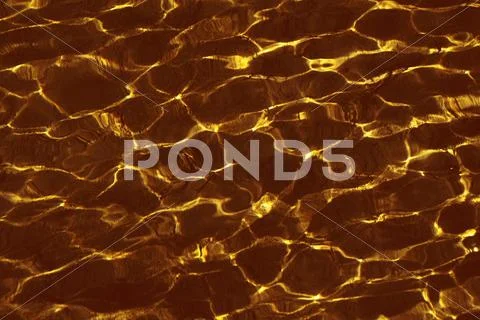 Golden ripples on the water Stock Photos