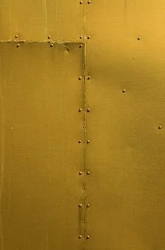 Golden Riveted Sheet Metal Background Stock Photos