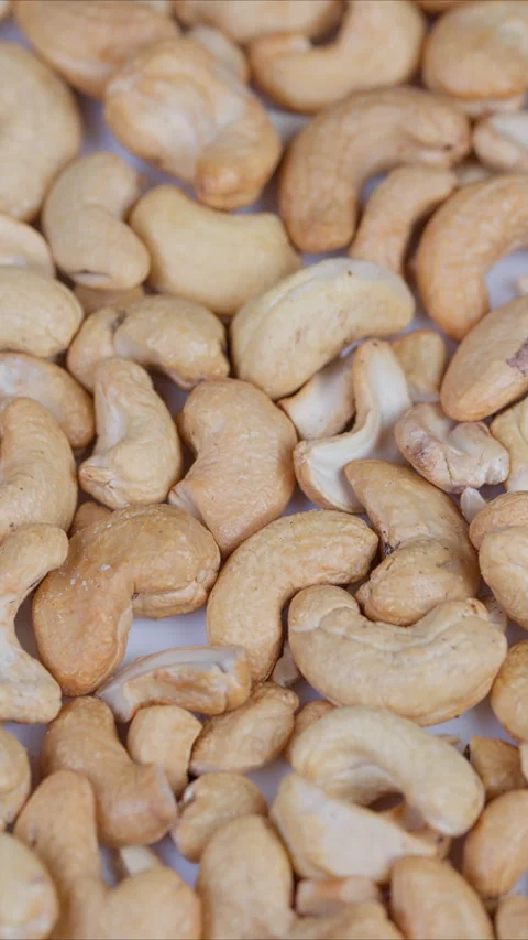 Golden roasted cashews detailed view. Closeup of roasted cashew nuts with salt. Video stock 333861153