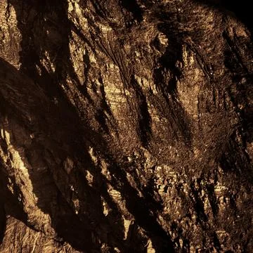 Golden Rock Texture with Dramatic Light and Shadow Stock Photos