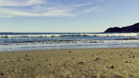 Golden Sand Beach from Low Angle with Waves coming in Stock Footage 169494587