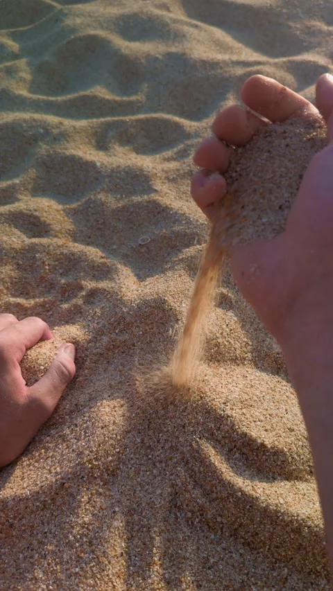 Golden Sand Falling Through Fingers in Slow Motion Видео 341423620