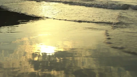Golden sand with rolling waves at sunset Stock Footage 112952260