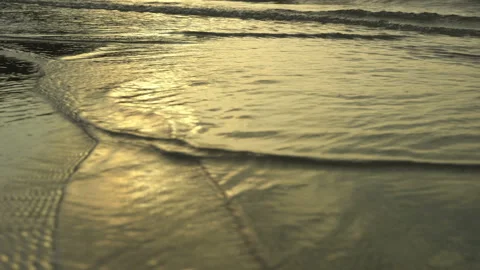 Golden sand with rolling waves at sunset Stock Footage 112952265