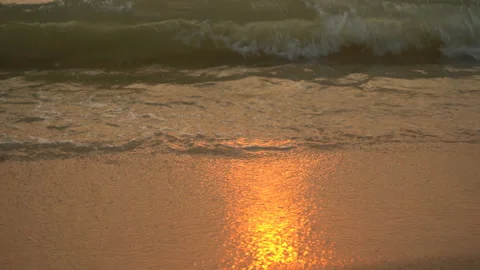Golden sand with rolling waves at sunset Stock Footage 112952356