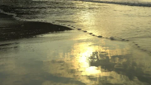 Golden sand with rolling waves at sunset Stock Footage 112952447
