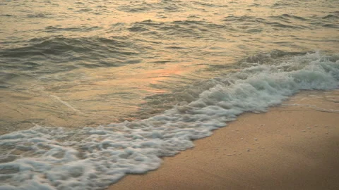 Golden sand with rolling waves at sunset Stock Footage 112952484