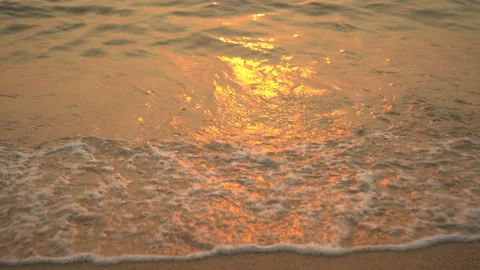 Golden sand with rolling waves at sunset Stock Footage 112952508