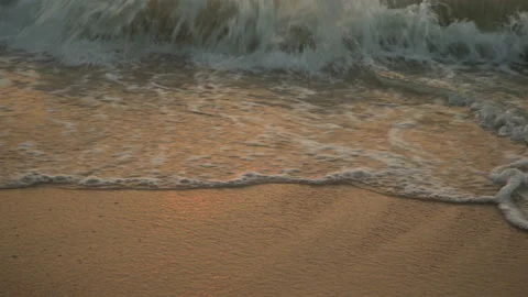 Golden sand with rolling waves at sunset Stock Footage 112952557