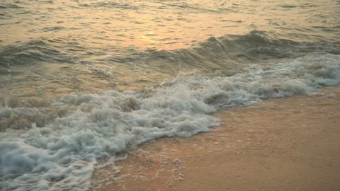 Golden sand with rolling waves at sunset Stock Footage 112952561