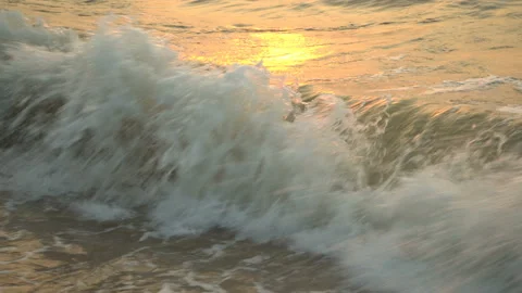 Golden sand with rolling waves at sunset Stock Footage 112952578