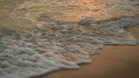 Golden sand with rolling waves at sunset Stock Footage 112952606