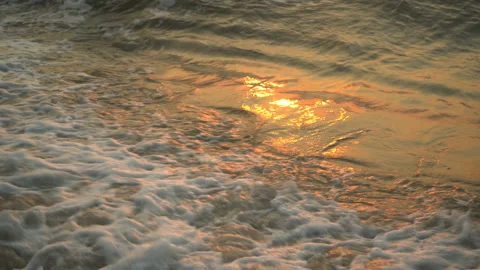Golden sand with rolling waves at sunset Stock Footage 112952636