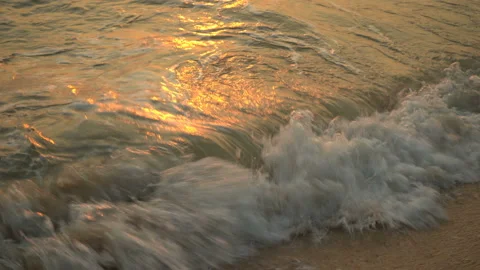 Golden sand with rolling waves at sunset Stock Footage 112952684