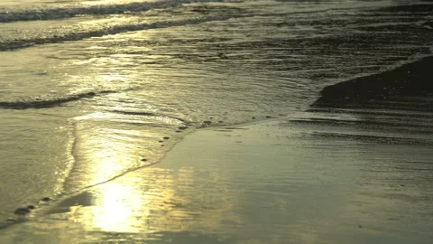 Golden sand with rolling waves at sunset Stock Footage 112952688