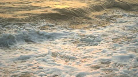Golden sand with rolling waves at sunset Stock Footage 112952691