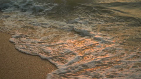 Golden sand with rolling waves at sunset Stock Footage 112952778