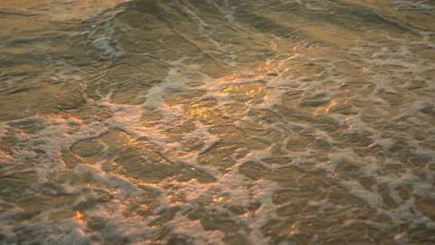 Golden sand with rolling waves at sunset Stock Footage 112952781