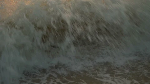 Golden sand with rolling waves at sunset Stock Footage 112952835