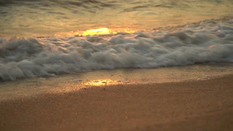 Golden sand with rolling waves at sunset Stock Footage 112952855