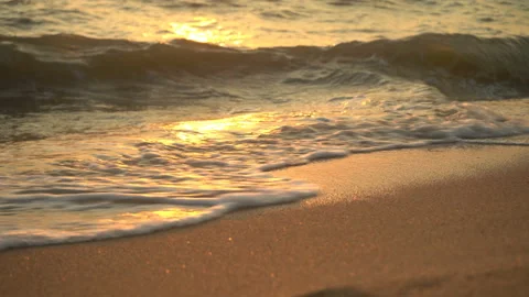 Golden sand with rolling waves at sunset Stock Footage 112952872
