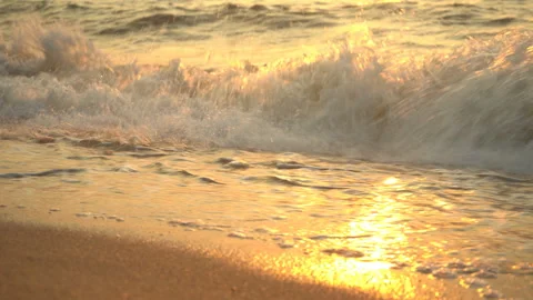 Golden sand with rolling waves at sunset Stock Footage 112952931