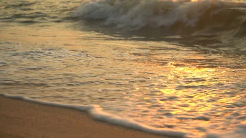 Golden sand with rolling waves at sunset Stock Footage 112952934