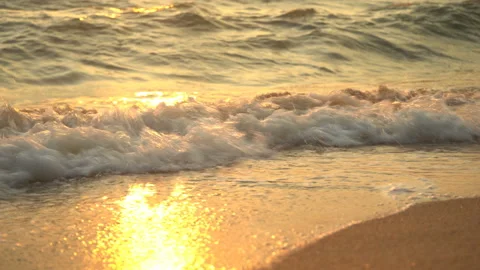 Golden sand with rolling waves at sunset Stock Footage 112952938