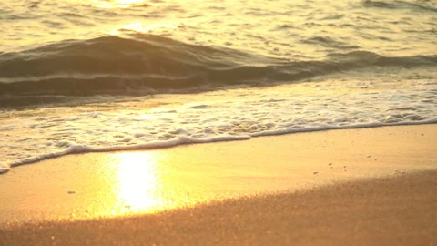 Golden sand with rolling waves at sunset Stock Footage 112952978