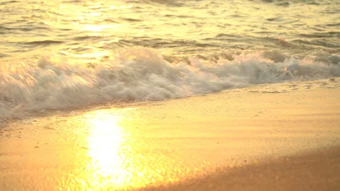 Golden sand with rolling waves at sunset Stock Footage 112953093